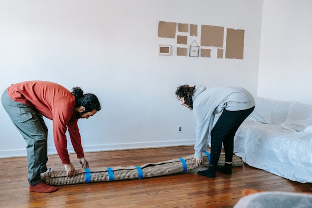 People removing a carpet